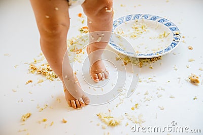 Baby feet dirty with food after lunch Stock Photo