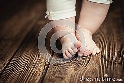 Baby feet doing the first steps. Baby`s first steps. Baby feet . Stock Photo