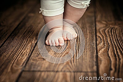 Baby feet doing the first steps. Baby`s first steps. Baby feet . Stock Photo