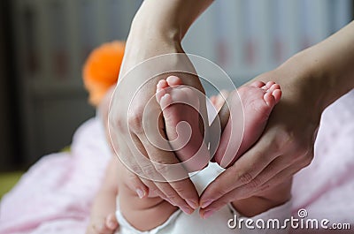 Baby feet in mother hands. Stock Photo