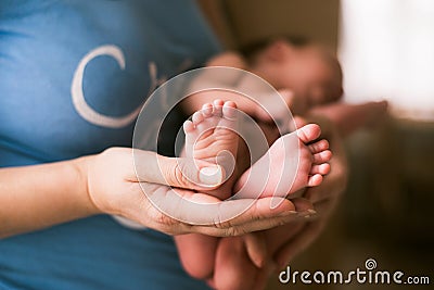 Baby feet in the mother hands Stock Photo