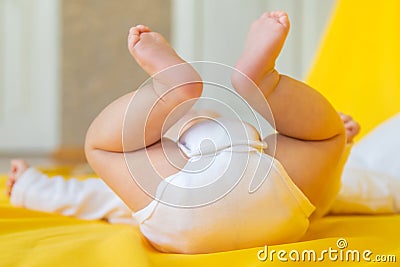 Baby feet on a yellow background. Selective focus Stock Photo