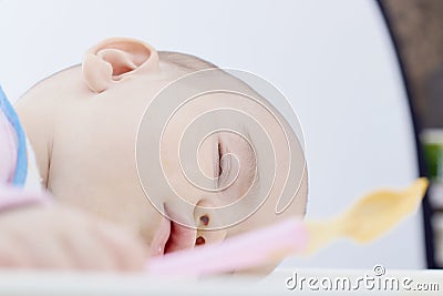 Baby fell asleep while feeding on a white background isolate Stock Photo