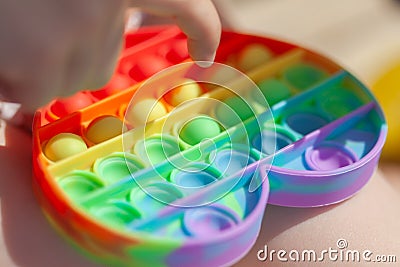 Baby fingers and antistress toy - popit, simple dimple Stock Photo