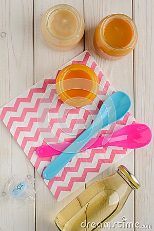 Baby food, spoons and pacifier Stock Photo