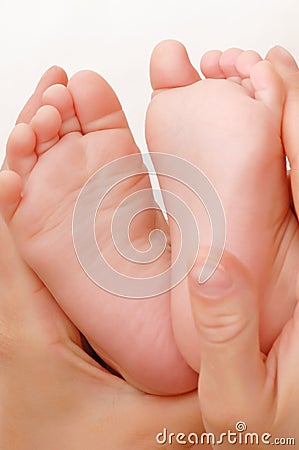 Baby foot massage Stock Photo