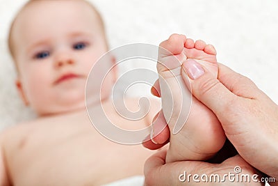 Baby foot massage Stock Photo