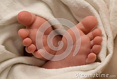 Baby foots in bedsheet Stock Photo