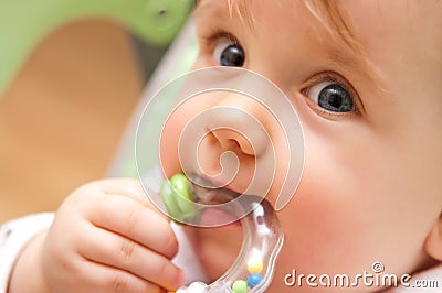 Baby girl biting toy Stock Photo