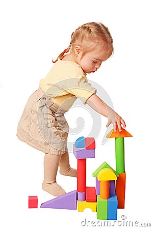 Baby girl building from toy blocks. Stock Photo