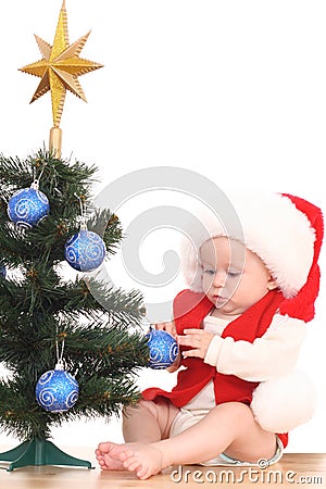 Baby girl and Christmas tree Stock Photo