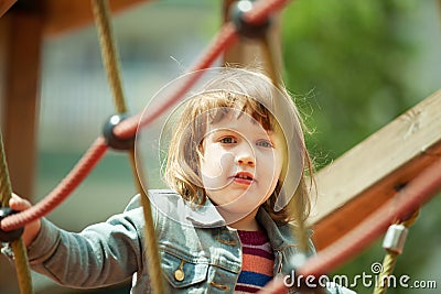 Baby girl climbing at ropes Stock Photo
