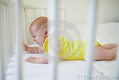 Baby girl in co-sleeper crib Stock Photo