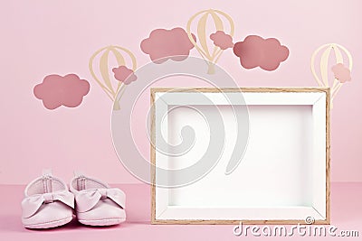 Baby girl cute pink shoes over the pink pastel background with clouds and ballons Stock Photo