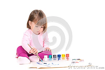 Baby girl draws by paints Stock Photo