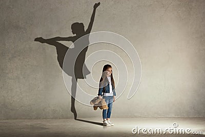 Baby girl dreaming a dancing ballet on the stage. Childhood concept. Stock Photo