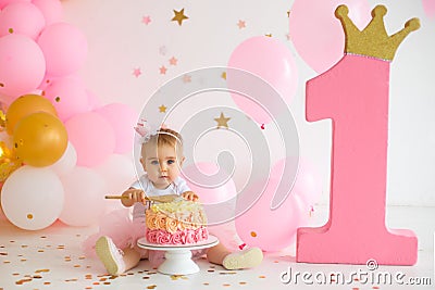 Baby girl at first birthday with smash cake Stock Photo