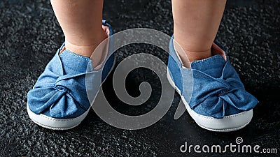 Baby girl first blue denim shoes with bow Stock Photo