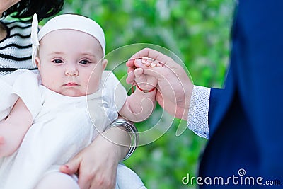 Baby girl holding her dads hand portrait Stock Photo