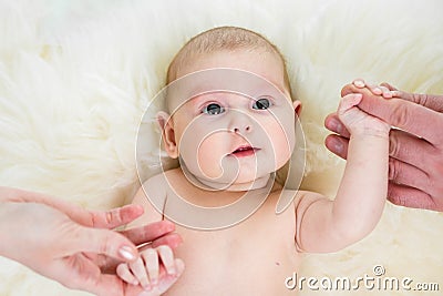 Baby girl holding parental hands Stock Photo