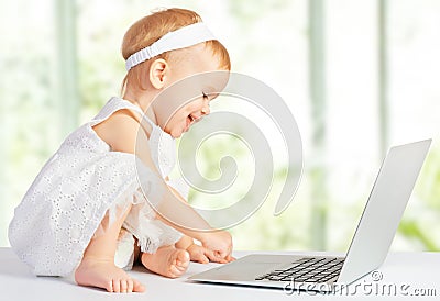 Baby girl at laptop computer Stock Photo