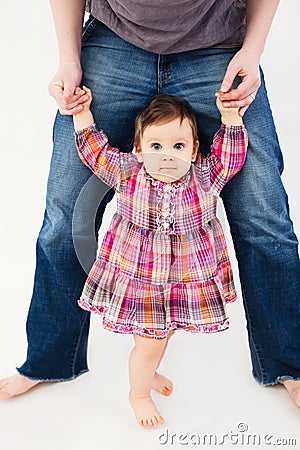 Baby girl learning to walk Stock Photo