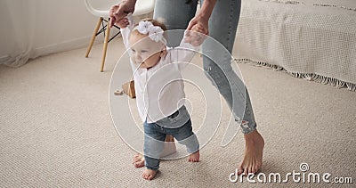 baby learning to walk on hardwood floors