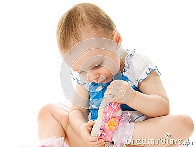 Baby girl looks at his shoe. Stock Photo