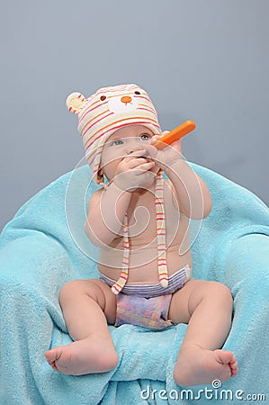 Baby girl looks at the spoon Stock Photo