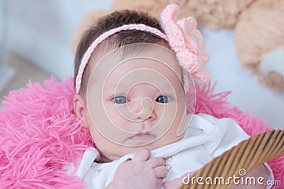 Baby girl newborn portrait in pink blanket lying in basket, cute face, new life Stock Photo
