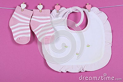 Baby girl nursery cute pink and white stripe socks and bib Stock Photo