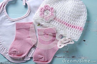 Baby girl nursery dummy pacifier, socks, bib and bonnet Stock Photo