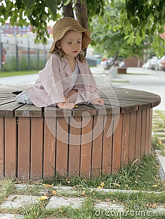 Baby girl in pin clothes and a straw Stock Photo