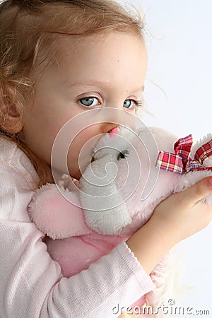 Baby girl and pink bunny Stock Photo