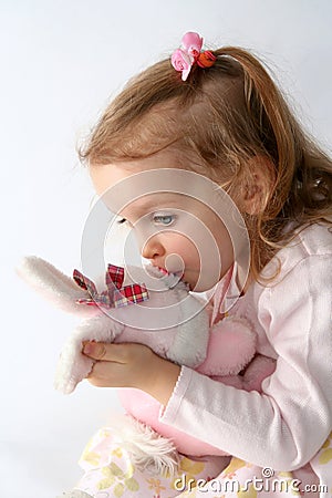 Baby girl and pink bunny Stock Photo