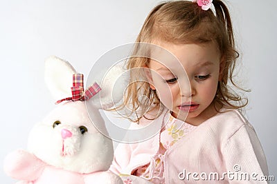 Baby girl and pink bunny Stock Photo