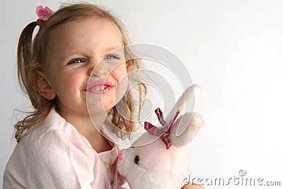 Baby girl and pink bunny Stock Photo