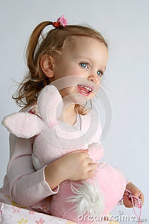 Baby girl and pink bunny Stock Photo