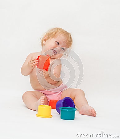 Baby girl playing colorful caps Stock Photo