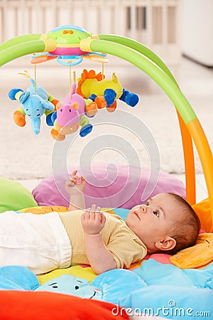 Baby girl on playmat Stock Photo