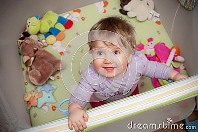 Baby girl in playpen Stock Photo