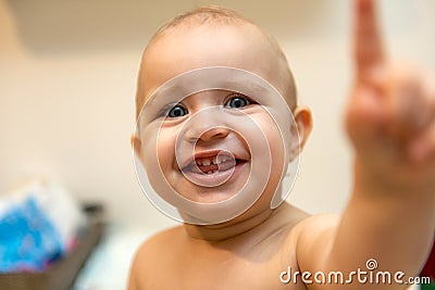 Baby girl pointing his finger straight to the camera. Cute adorable baby after bath time Stock Photo