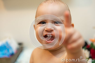 Baby girl pointing his finger straight to the camera. Cute adorable baby after bath time Stock Photo