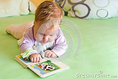 Baby girl reading Stock Photo