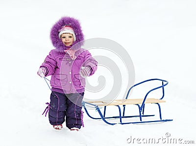 baby girl with sledges Stock Photo