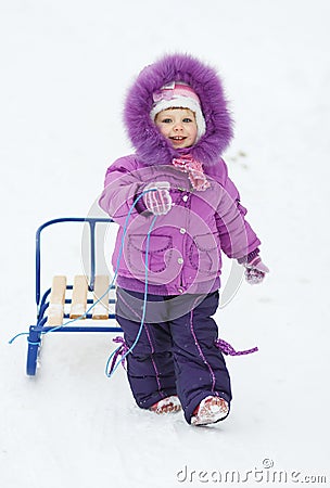 baby girl with sledges Stock Photo