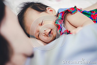 Baby Girl sleep with Aunty Stock Photo