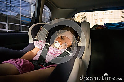 Baby girl sleeping in the car Stock Photo