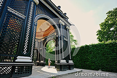 Baby girl under wooden arbor arch at Schonbrunn Palace in Vienna, Austria Editorial Stock Photo