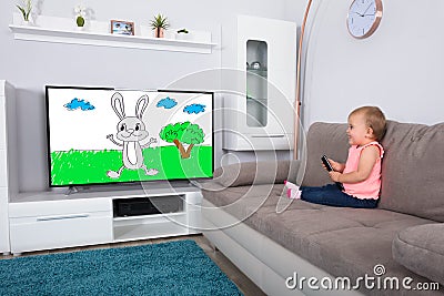 Baby Girl Watching Cartoon On Television Stock Photo